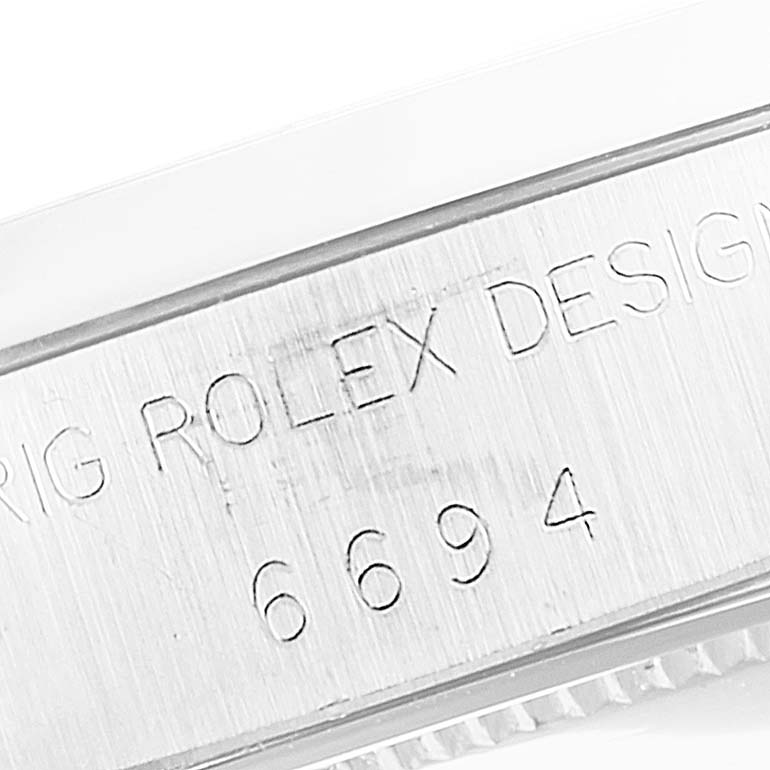 This image shows an engraved part of the side of the Rolex Vintage Collection 6694 Men's Stainless Steel Black Dial 6694 Men's Stainless Steel Black Dial model, specifically the part with the model number 6694.