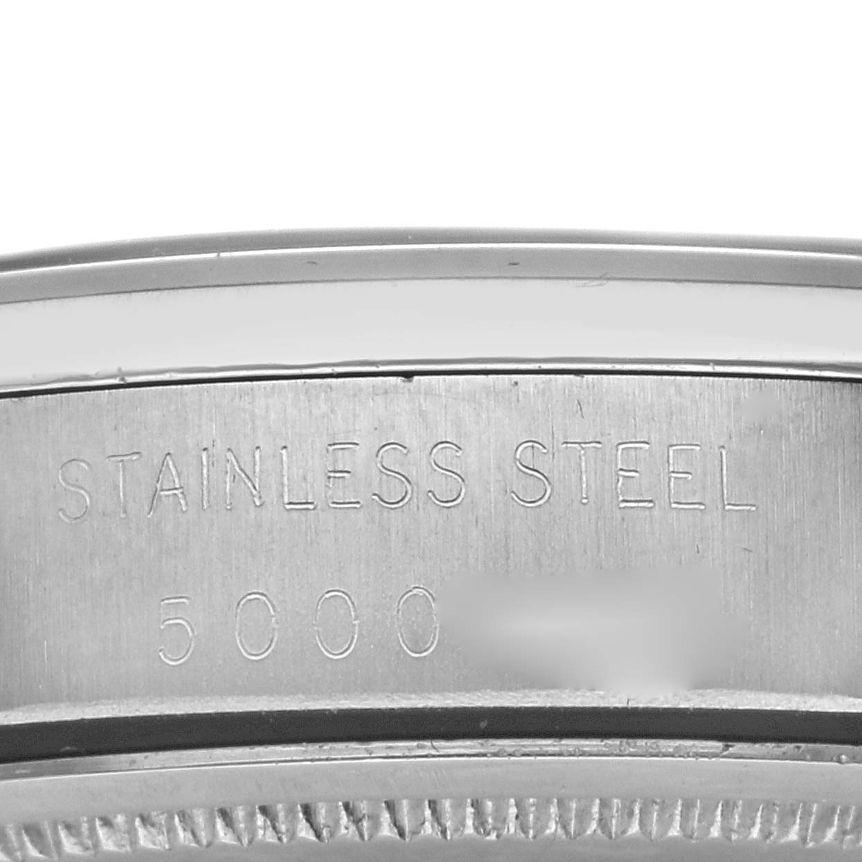 This image shows a close-up of the side engraving on the stainless steel case of a Rolex Vintage Collection 6694 Men's Stainless Steel Champagne Dial 6694 Men's Stainless Steel Champagne Dial model.