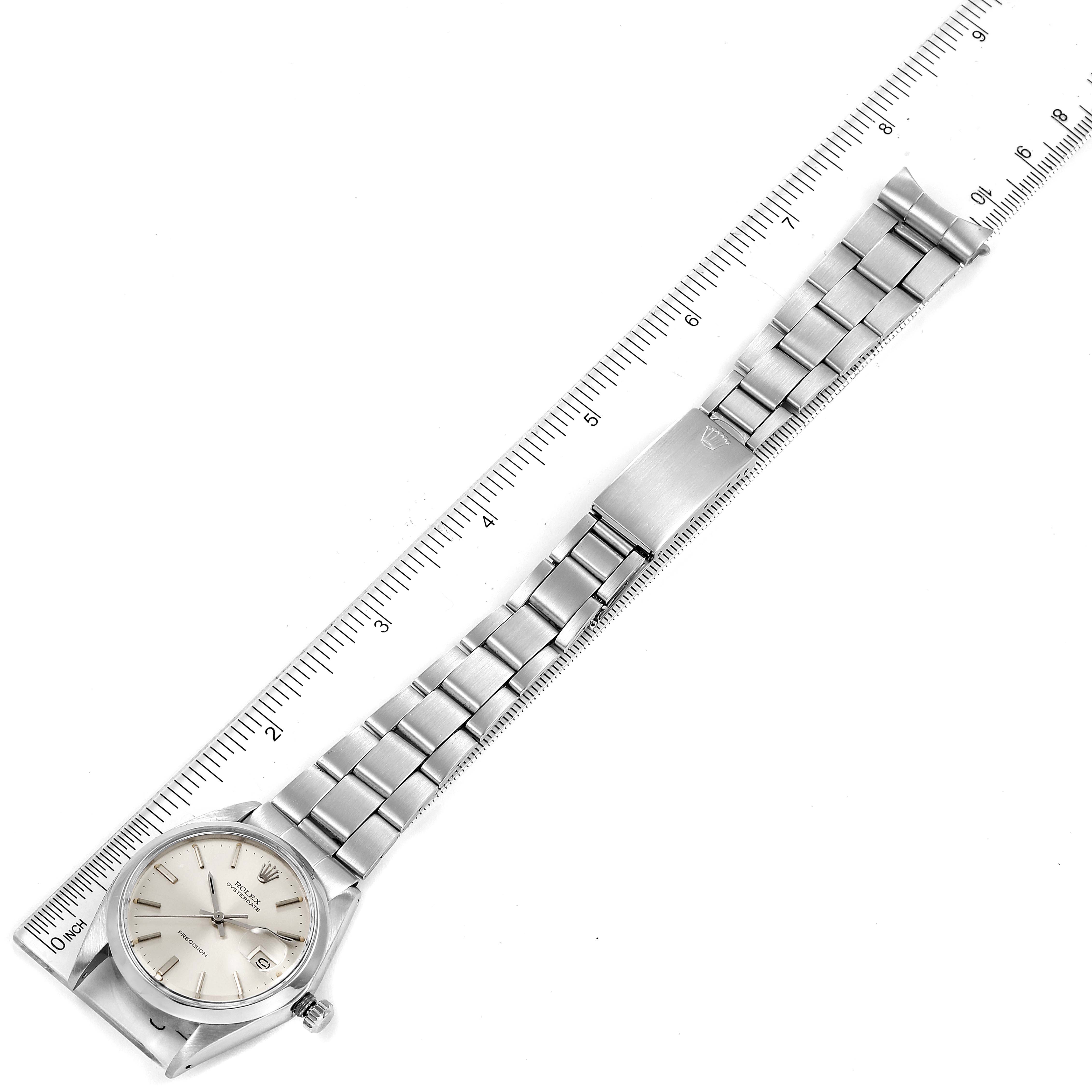 The image shows a top-down view of the Vintage Collection Rolex watch displaying the watch face, bracelet, and clasp alongside a measuring ruler.