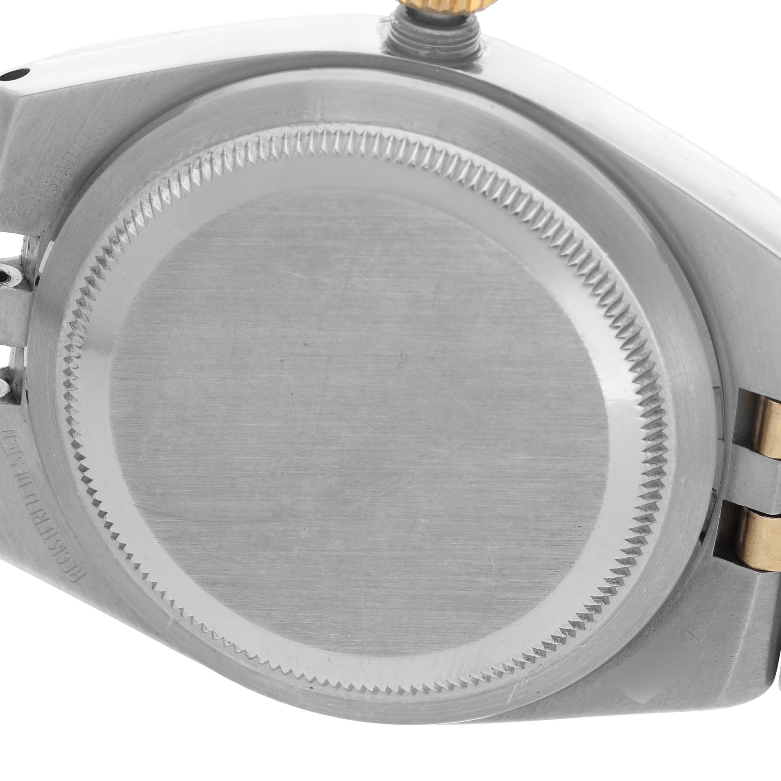 The image shows the case back and partially visible crown and bracelet of a Rolex Oysterquartz 17013 Men
s Steel and Gold (two tone) Blue Dial 17013 Men
s Steel and Gold (two tone) Blue Dial watch.