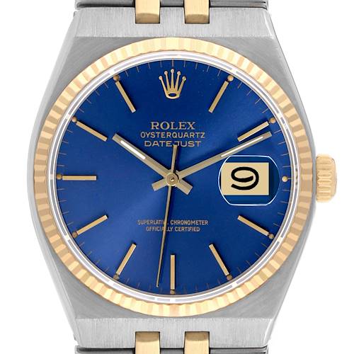 The image shows a front view of a Rolex Oysterquartz Datejust watch featuring a blue dial, date window, and gold-trimmed bezel.