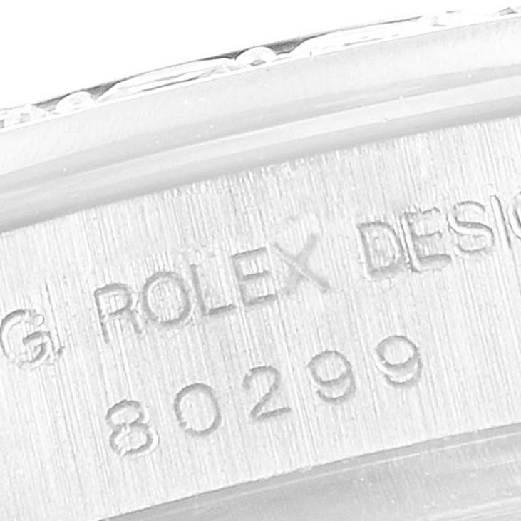 This close-up shot shows part of the casing with engraved text and numbers on a Rolex Pearlmaster 80299 Women's White Gold Mother of Pearl Dial 80299 Women's White Gold Mother of Pearl Dial watch.