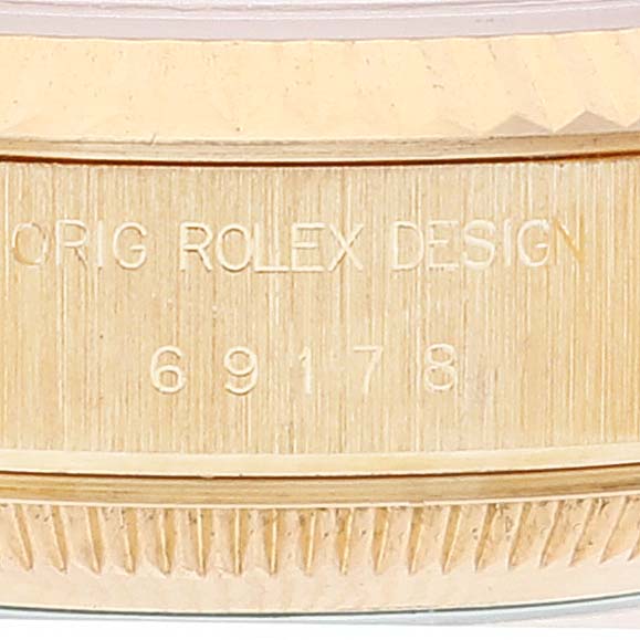 This image shows the side view of the case of a Rolex President 69178 Women's Yellow Gold Black Dial 69178 Women's Yellow Gold Black Dial model watch, with visible engraved design and model number.