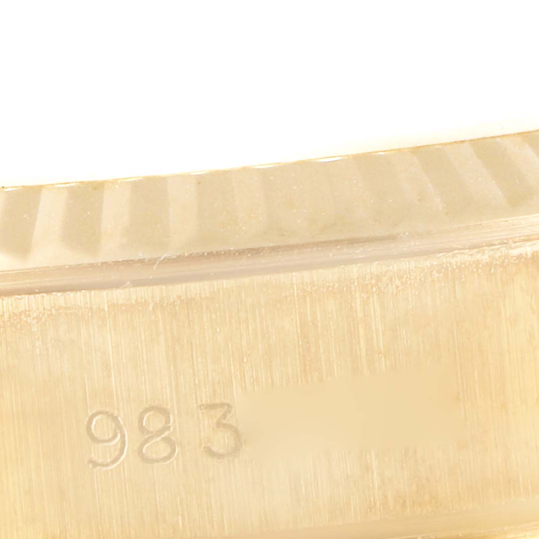 This close-up image shows part of the fluted bezel and case side of a Rolex President 69178 Women
s Yellow Gold Champagne Dial 69178 Women
s Yellow Gold Champagne Dial model, featuring engraved numbers.