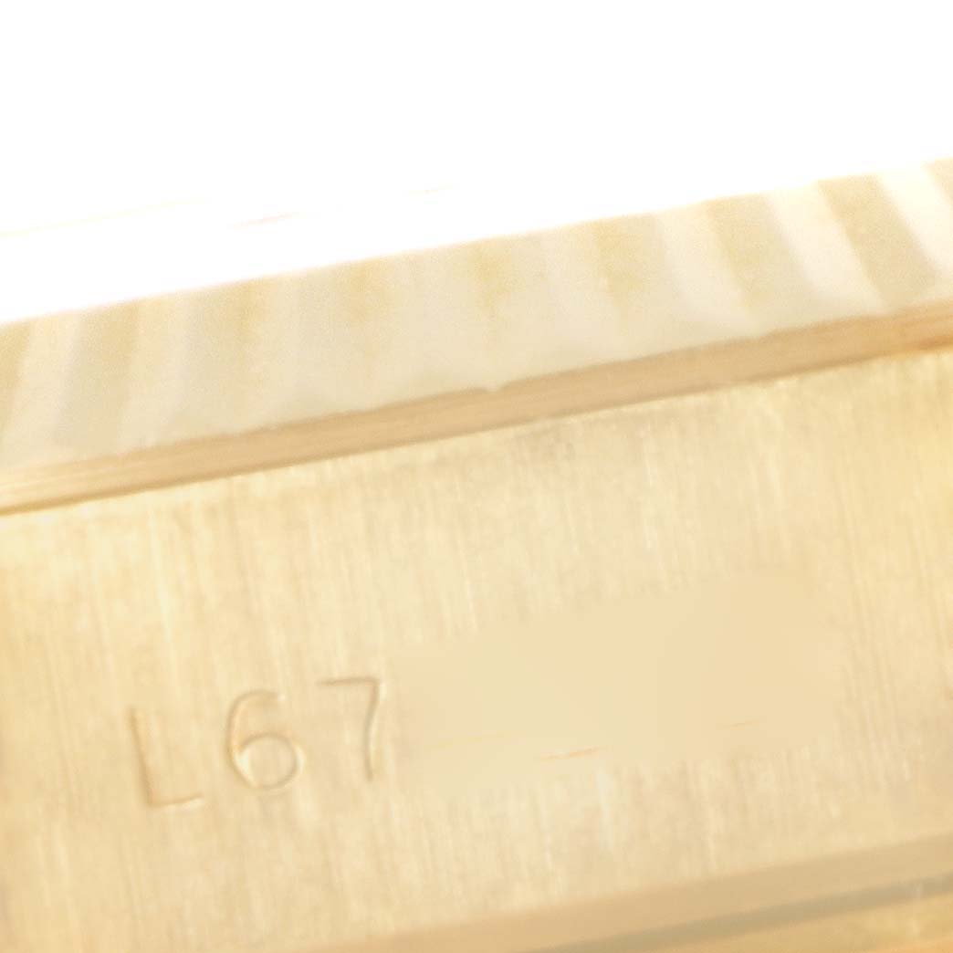 This image shows a close-up of the engraved serial number area on a Rolex President 69178 Women
s Yellow Gold Champagne Dial 69178 Women
s Yellow Gold Champagne Dial model watch case.