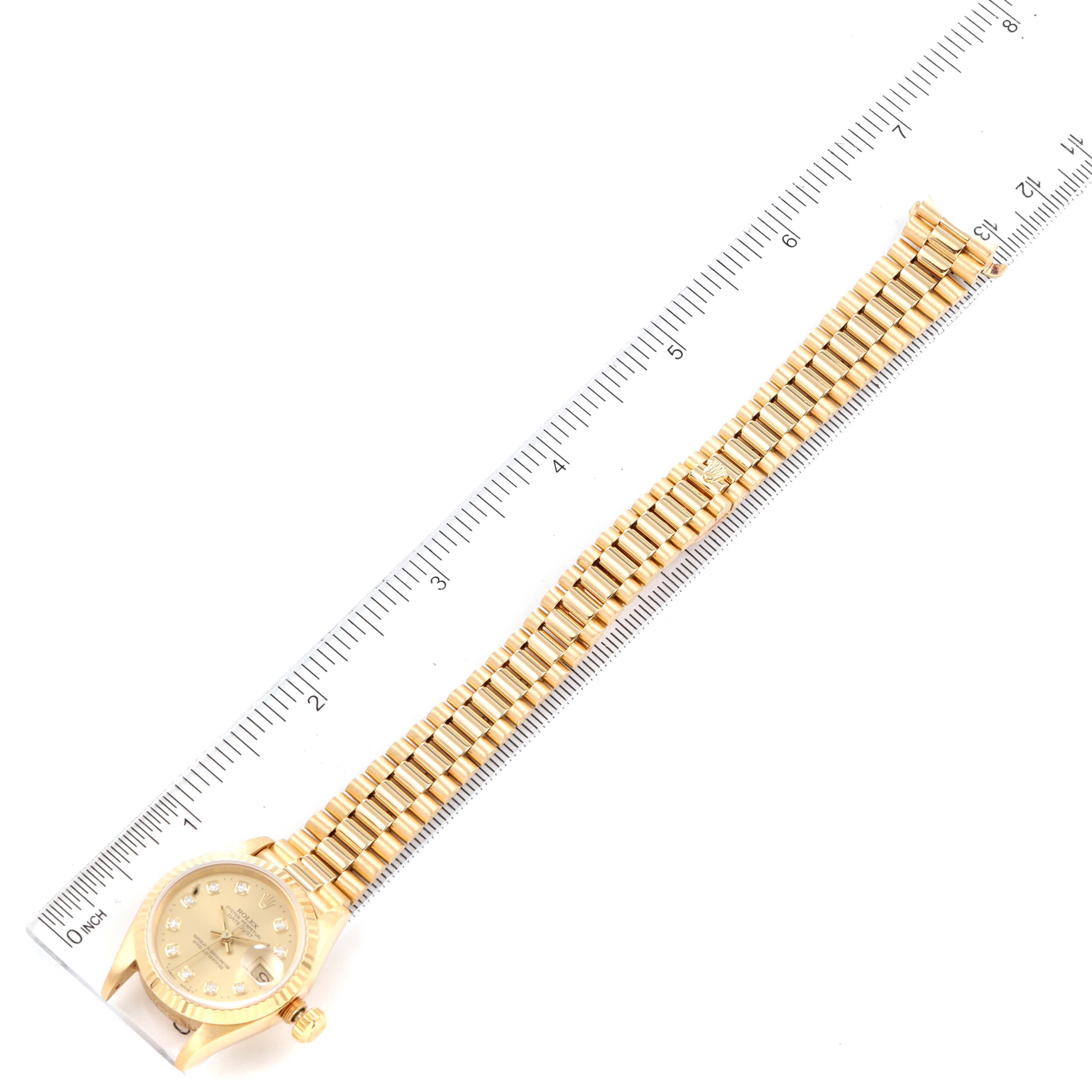 The Rolex President 69178 Women
s Yellow Gold Champagne Dial 69178 Women
s Yellow Gold Champagne Dial watch is shown flat with its dial and full bracelet visible, measured alongside a ruler.