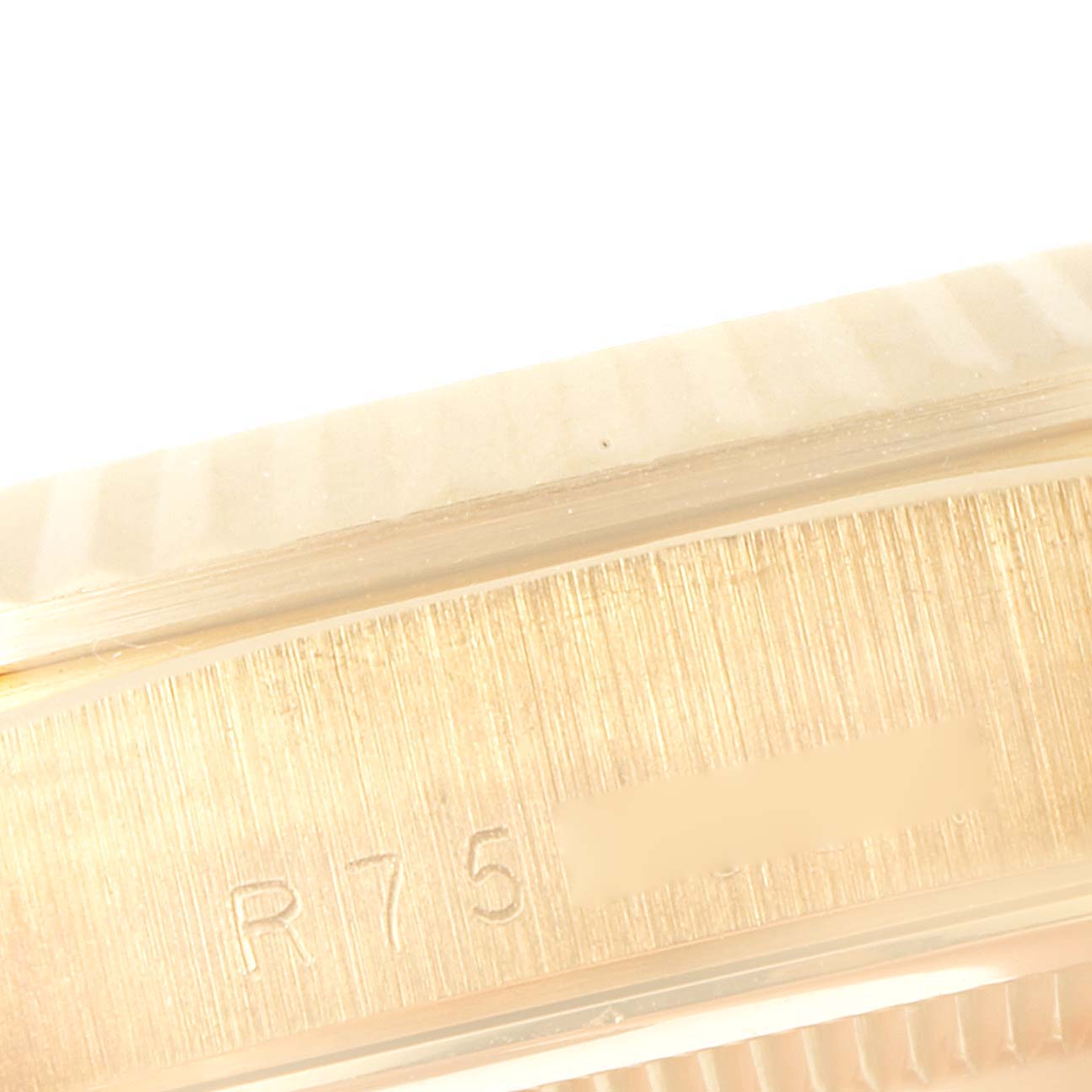 This is a close-up angle of the case side of a Rolex President 18238 Men's Yellow Gold Champagne Dial 18238 Men's Yellow Gold Champagne Dial model watch, showing engraved markings.
