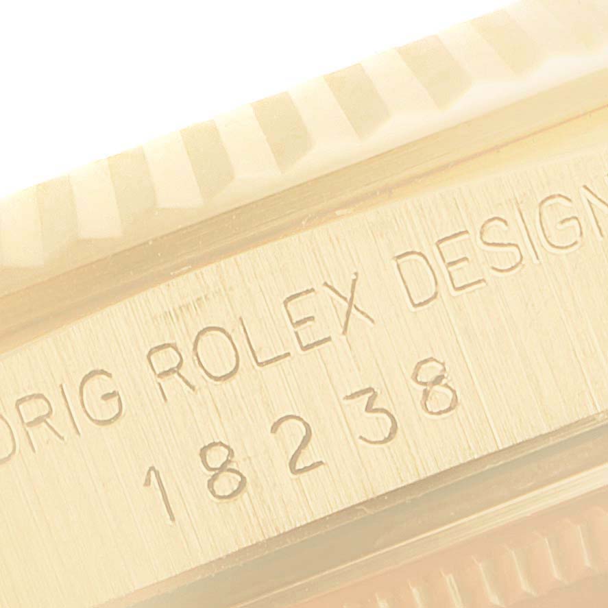 This close-up image shows the model number and part of the bezel of a Rolex President 18238 Men's Yellow Gold Champagne Dial 18238 Men's Yellow Gold Champagne Dial watch.