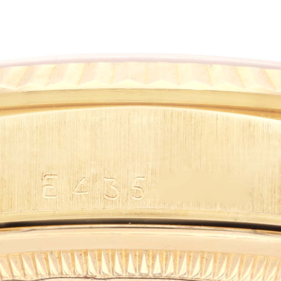 This image depicts a close-up view of the engraved bezel and case edge of a Rolex President 18238 Men's Yellow Gold Champagne Dial 18238 Men's Yellow Gold Champagne Dial model watch.