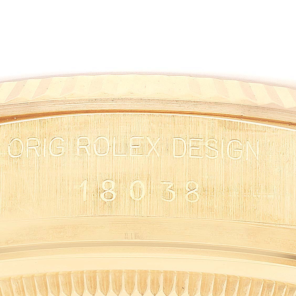 This image shows a close-up of the casing of a Rolex President 18038 Men's Yellow Gold Silver Dial 18038 Men's Yellow Gold Silver Dial model watch, highlighting the engraved design and model number.
