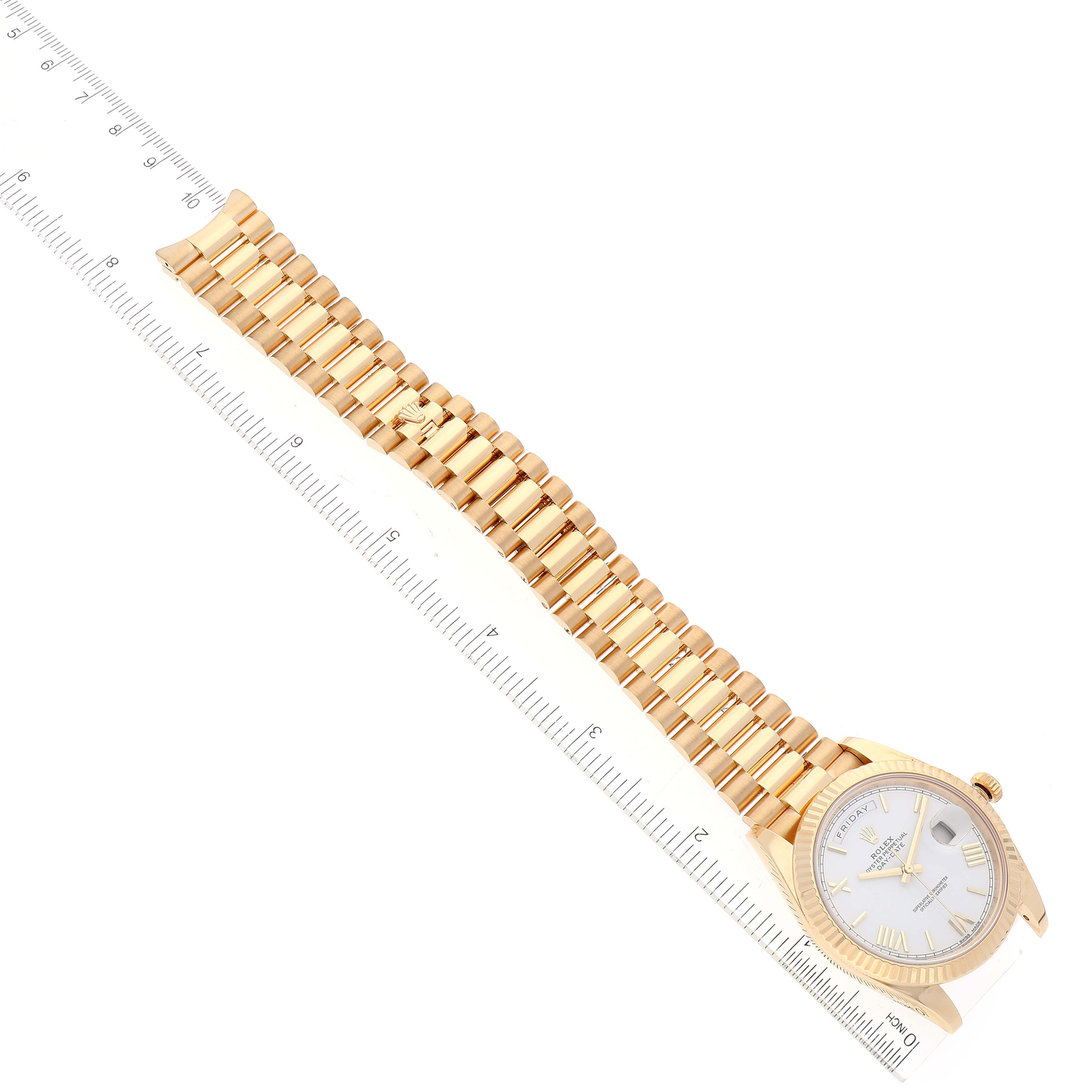 The image shows a Rolex President 228238 Men
s Yellow Gold White Dial 228238 Men
s Yellow Gold White Dial model watch from an angled top-down perspective, highlighting its dial and bracelet.