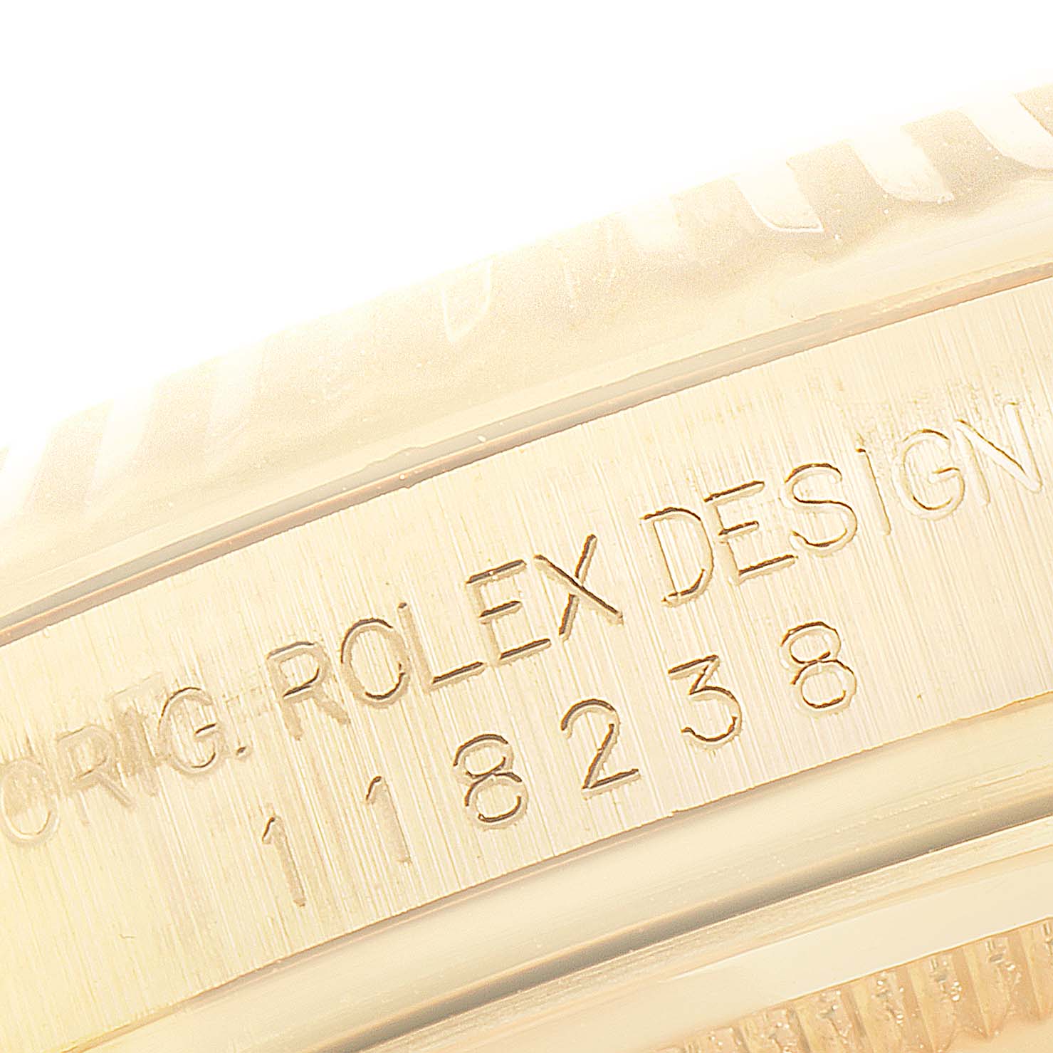 This close-up image shows the engraved serial number on the side of a Rolex President 118238 Men's Yellow Gold Champagne Dial 118238 Men's Yellow Gold Champagne Dial model watch.