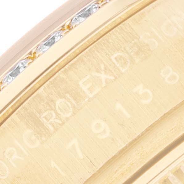 The image shows a close-up view of the case edge and serial number engraving on a Rolex President 179138 Women's Yellow Gold Champagne Dial 179138 Women's Yellow Gold Champagne Dial model watch.
