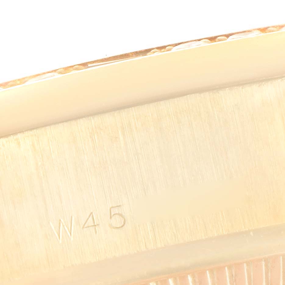 This close-up image shows a portion of the case back of a Rolex President 69068 Women
s Yellow Gold Champagne Dial 69068 Women
s Yellow Gold Champagne Dial model watch, including the engraved markings.