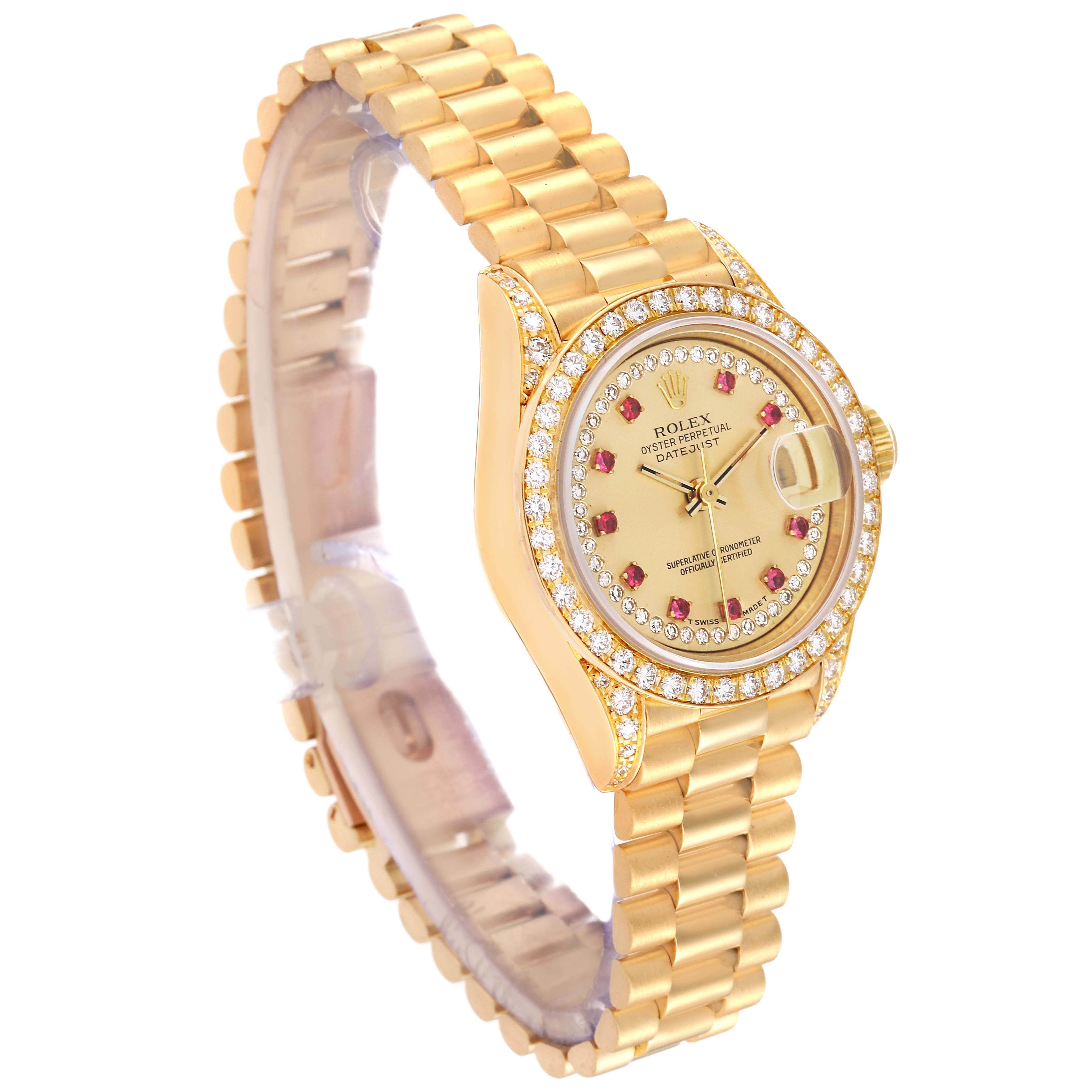The Rolex President 69158 Women
s Yellow Gold Champagne Dial 69158 Women
s Yellow Gold Champagne Dial model watch is shown at a three-quarter angle, displaying its gold bracelet, diamond bezel, and ruby-accented dial.