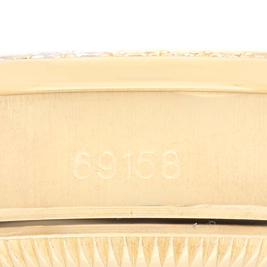 The image displays a close-up view of the side of a Rolex President 69158 Women
s Yellow Gold Champagne Dial 69158 Women
s Yellow Gold Champagne Dial model with the model number 69158 engraved.