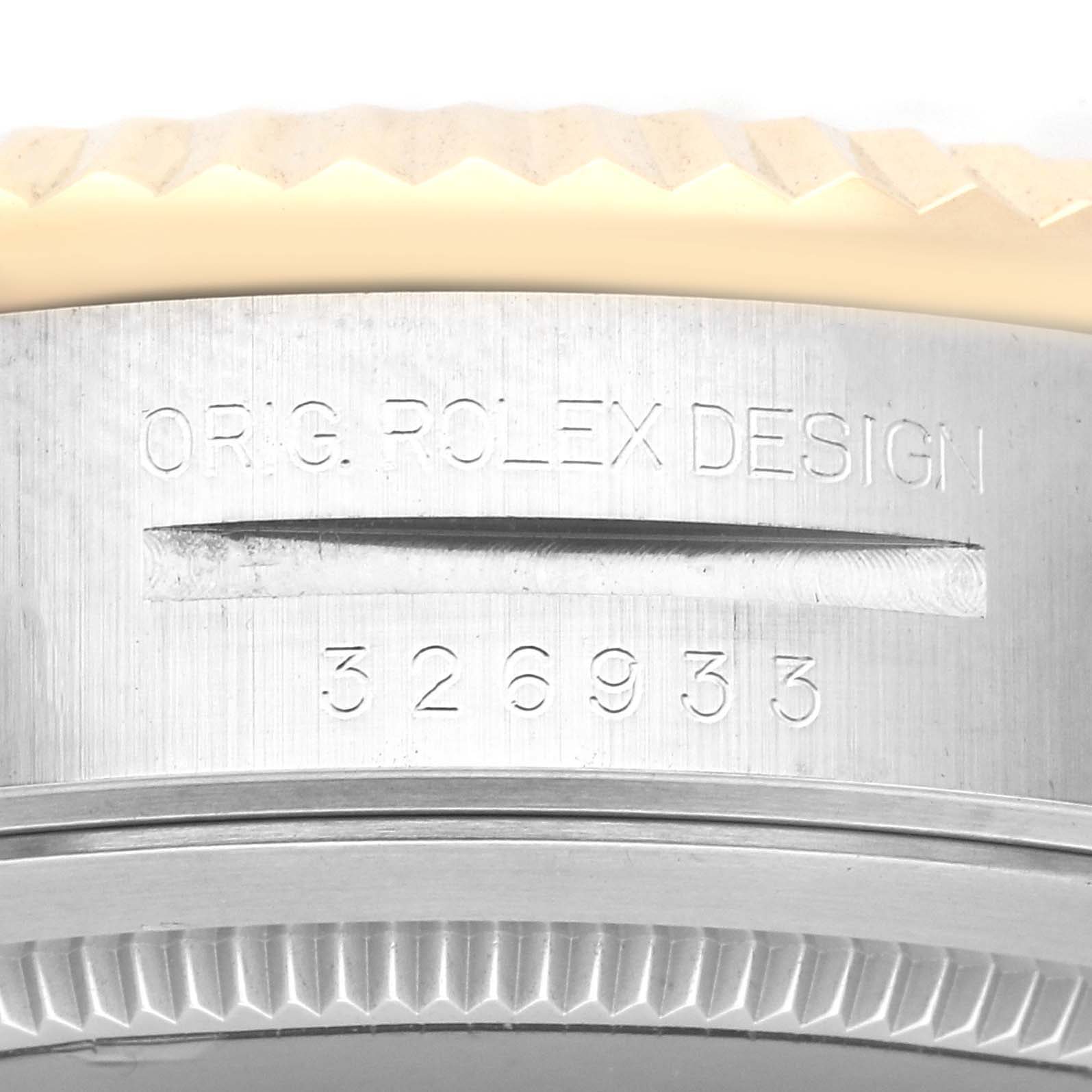 This image shows a close-up of the case side engraving and part of the bezel of a Rolex Sky-Dweller 326933 Men's Steel and Gold (two tone) Champagne Dial 326933 Men's Steel and Gold (two tone) Champagne Dial watch.
