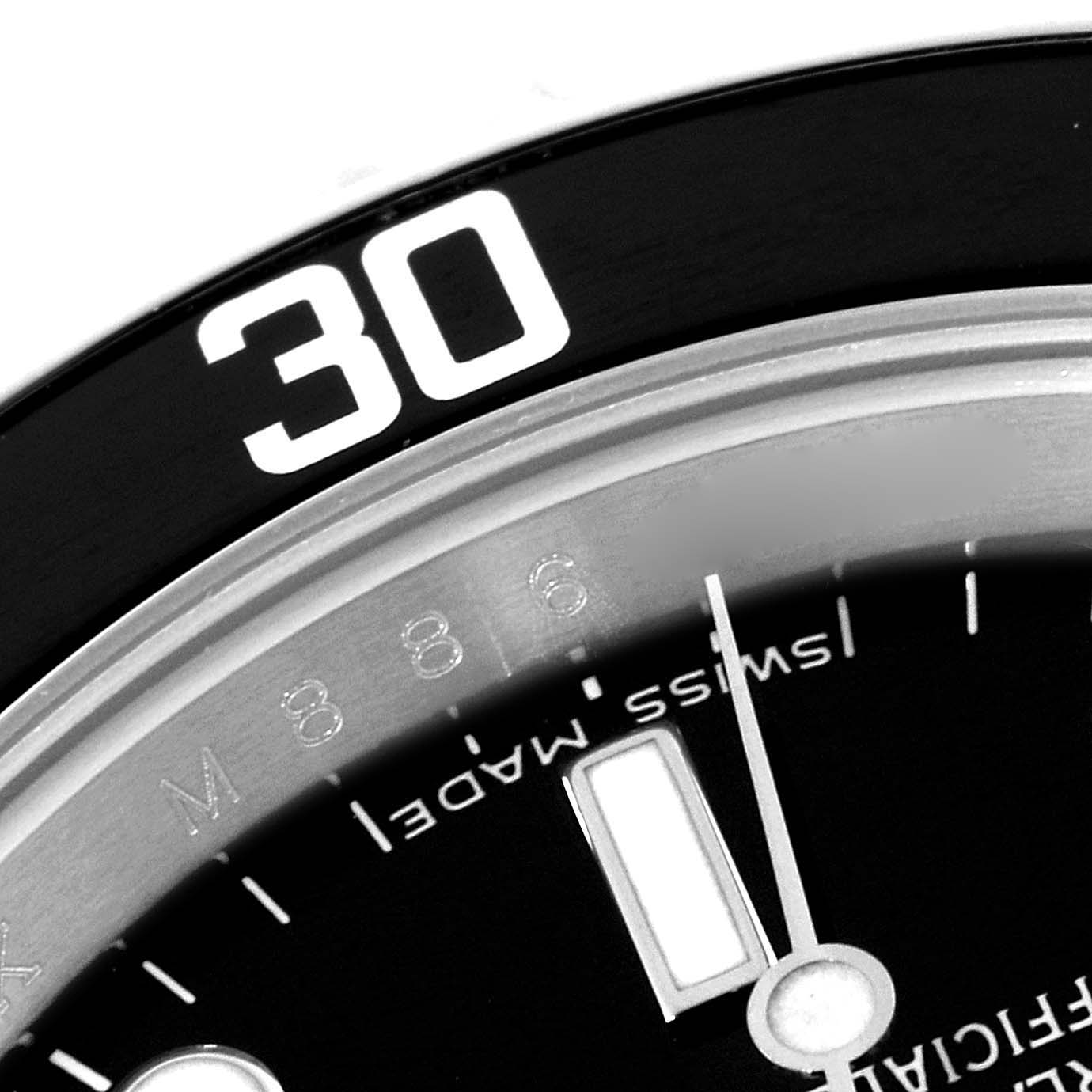 This close-up image of the Rolex Submariner 14060M Men
s Stainless Steel Black Dial 14060M Men
s Stainless Steel Black Dial watch shows part of the bezel with the number "30" and sections of the dial and minute hand.