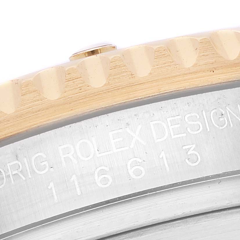 This close-up image shows the bezel and part of the case back of a Rolex Submariner 116613 Men's Steel and Gold (two tone) Blue Dial 116613 Men's Steel and Gold (two tone) Blue Dial watch.