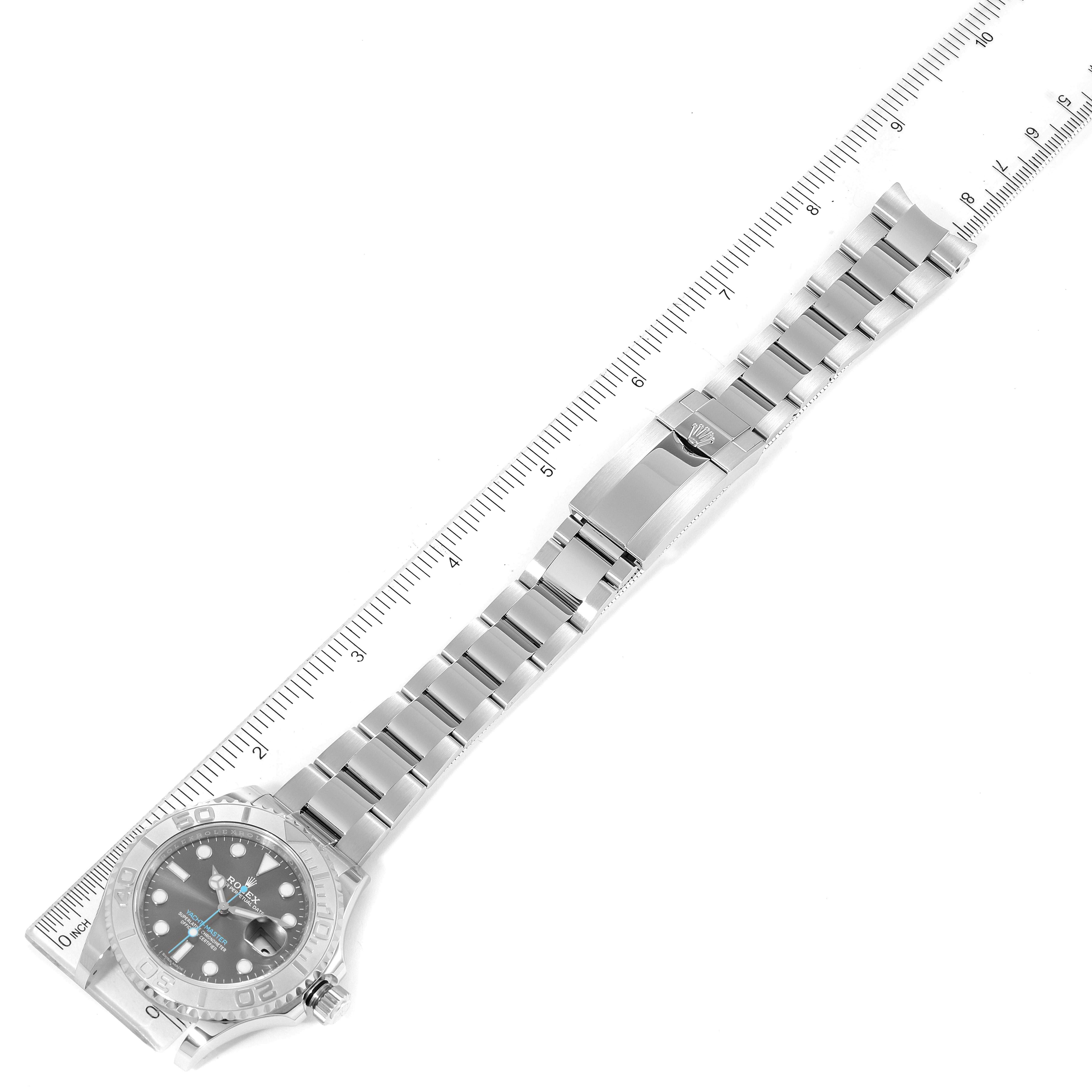 The image shows the full length, including the dial, bracelet, and clasp, of a Rolex Yacht-Master 116622 Men
s Stainless Steel Grey Dial 116622 Men
s Stainless Steel Grey Dial watch with a ruler for scale.