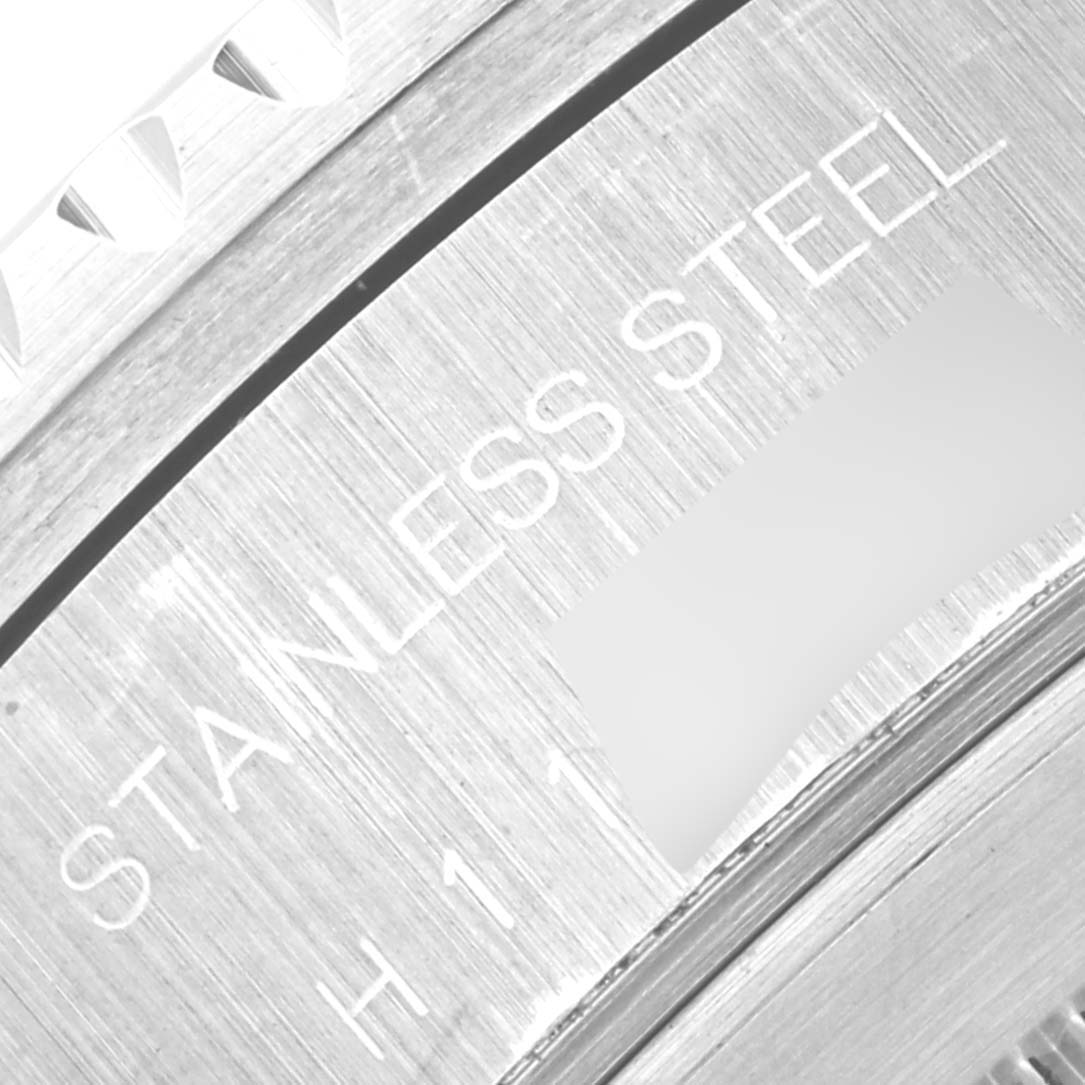 This close-up image shows the case back of the Tudor Prince 79270 Men's Stainless Steel Red Dial 79270 Men's Stainless Steel Red Dial watch and its "STAINLESS STEEL" engraving.