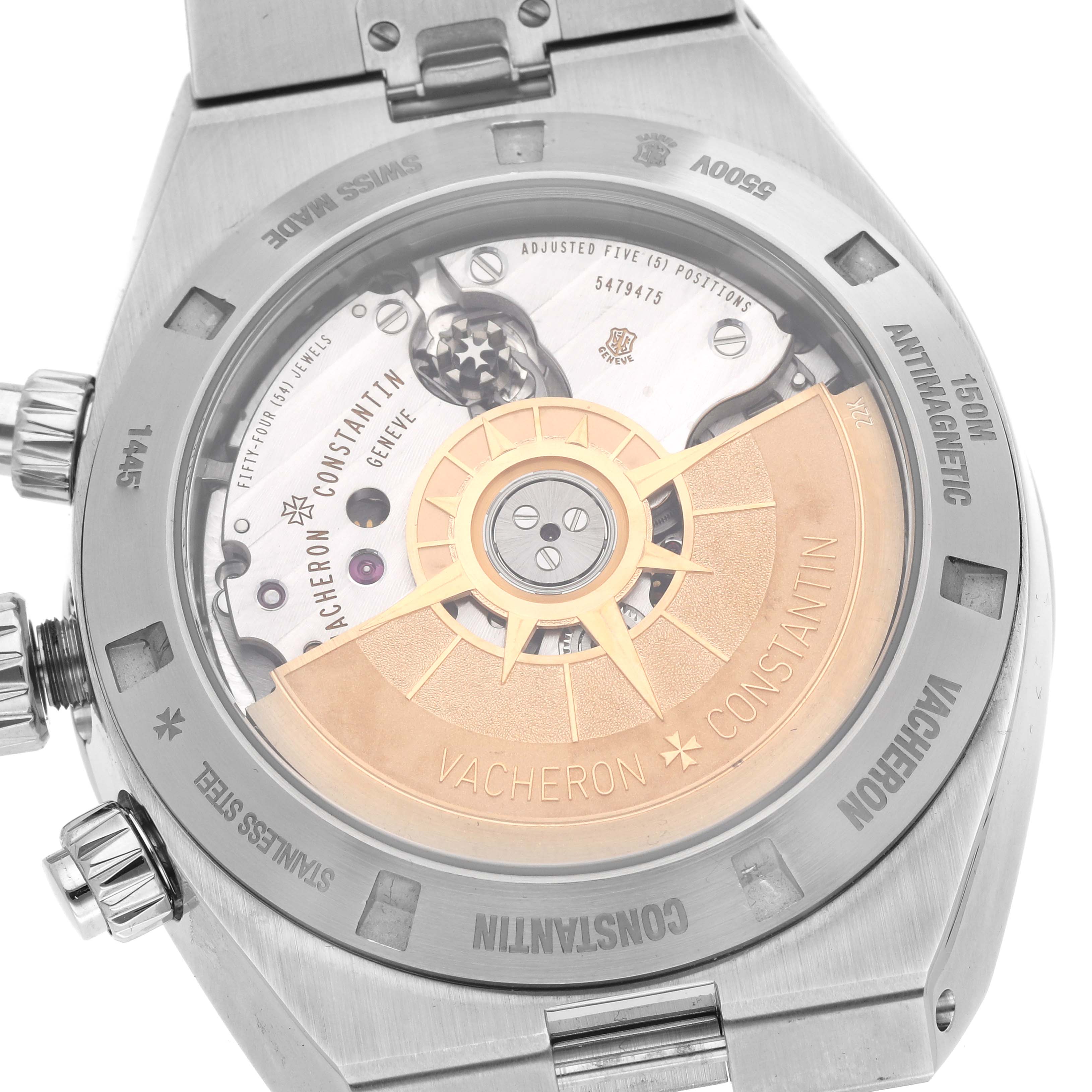 The image shows the case back and movement of a Vacheron Constantin Overseas 5500V/110A-B481 Men's Stainless Steel Black Dial 5500V/110A-B481 Men's Stainless Steel Black Dial watch, highlighting its intricate mechanisms and engravings.