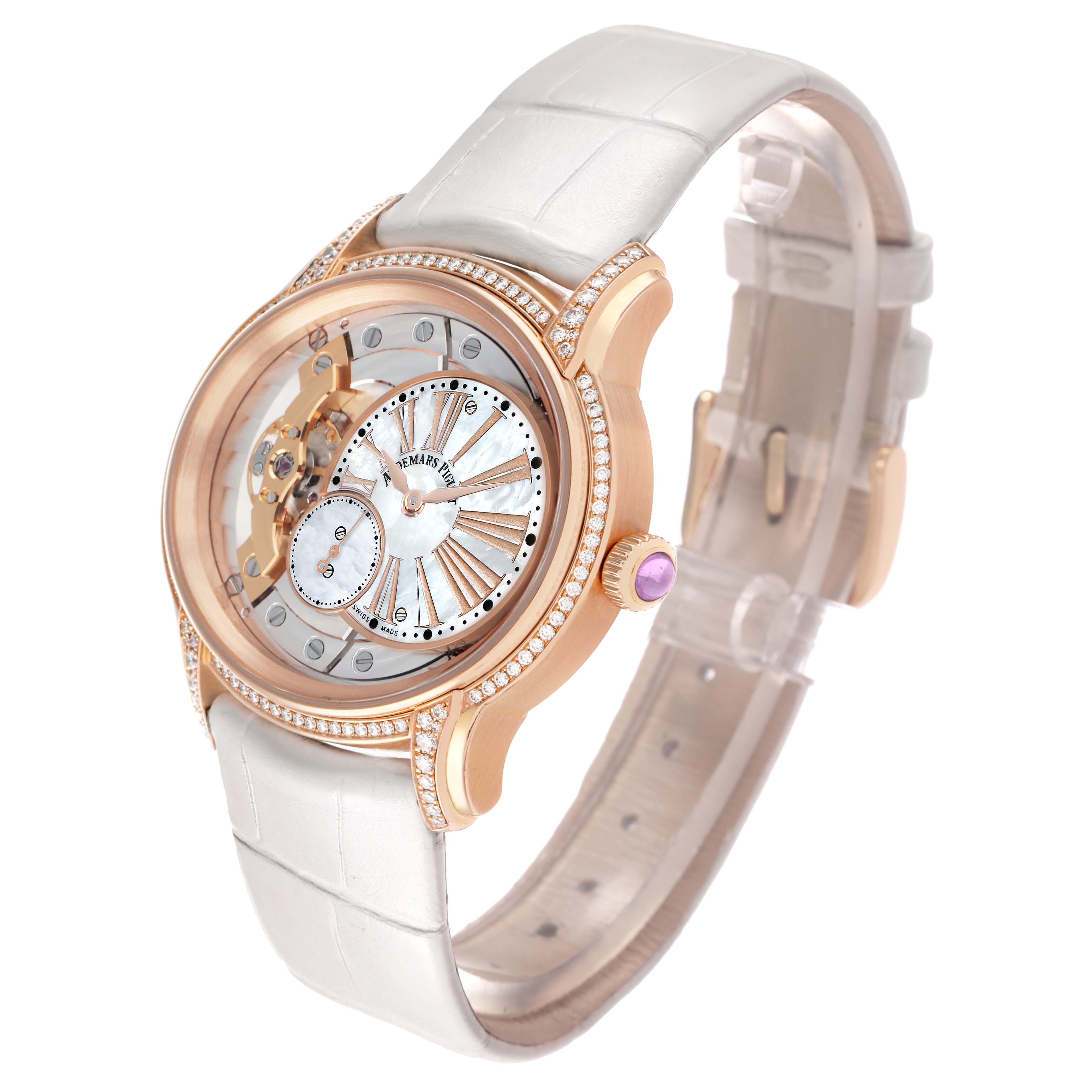The Audemars Piguet Millenary 77247OR Women
s Rose Gold Transparent Dial watch is shown at a three-quarter angle, highlighting its open-worked dial, pink gold case, and white strap.