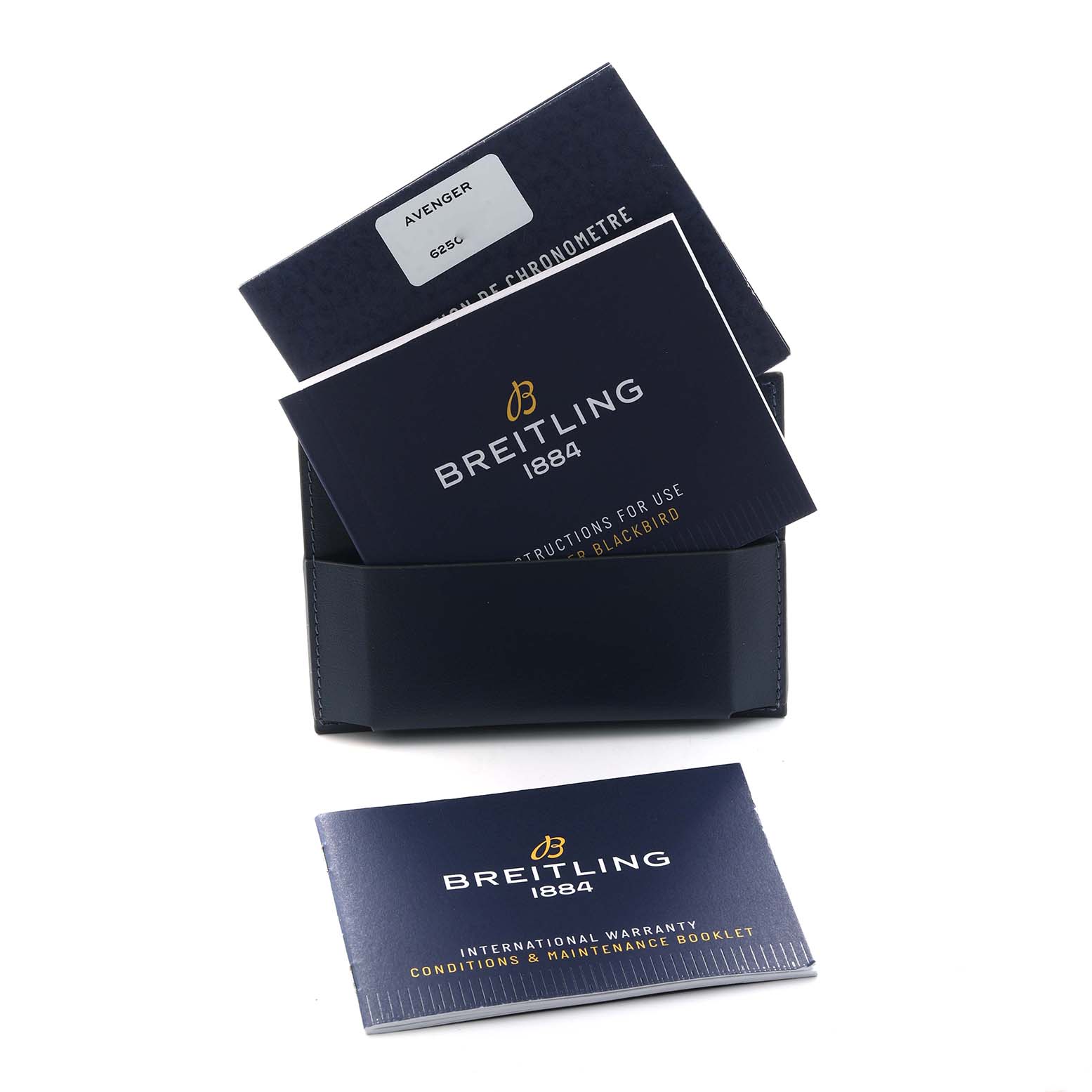 The image shows a Breitling Avenger A17318 Men
s Stainless Steel Black Dial watch
s instruction manuals and warranty booklet, viewed from above.