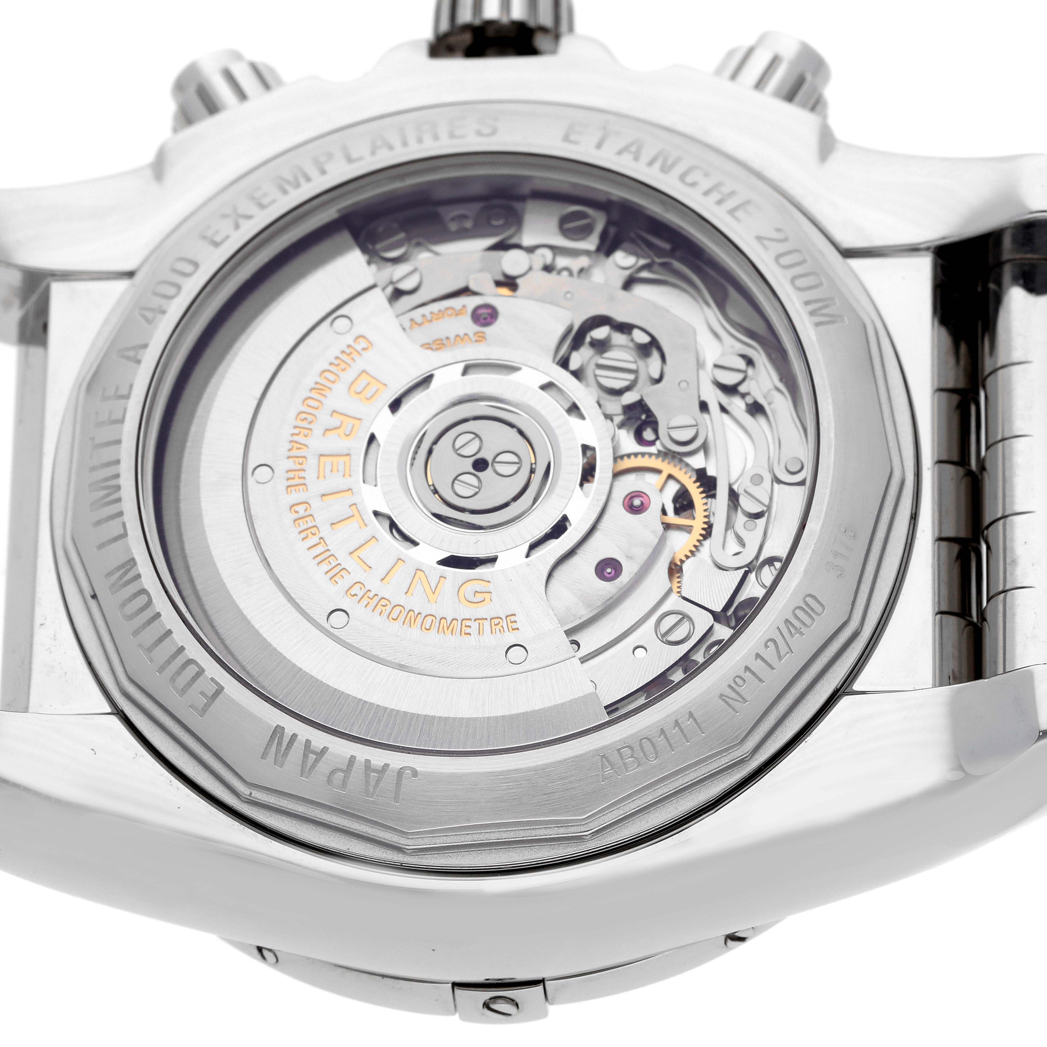 The image shows the back view of a Breitling Chronomat AB0111 Men
s Stainless Steel Black Dial watch, highlighting its automatic movement and limited edition details.