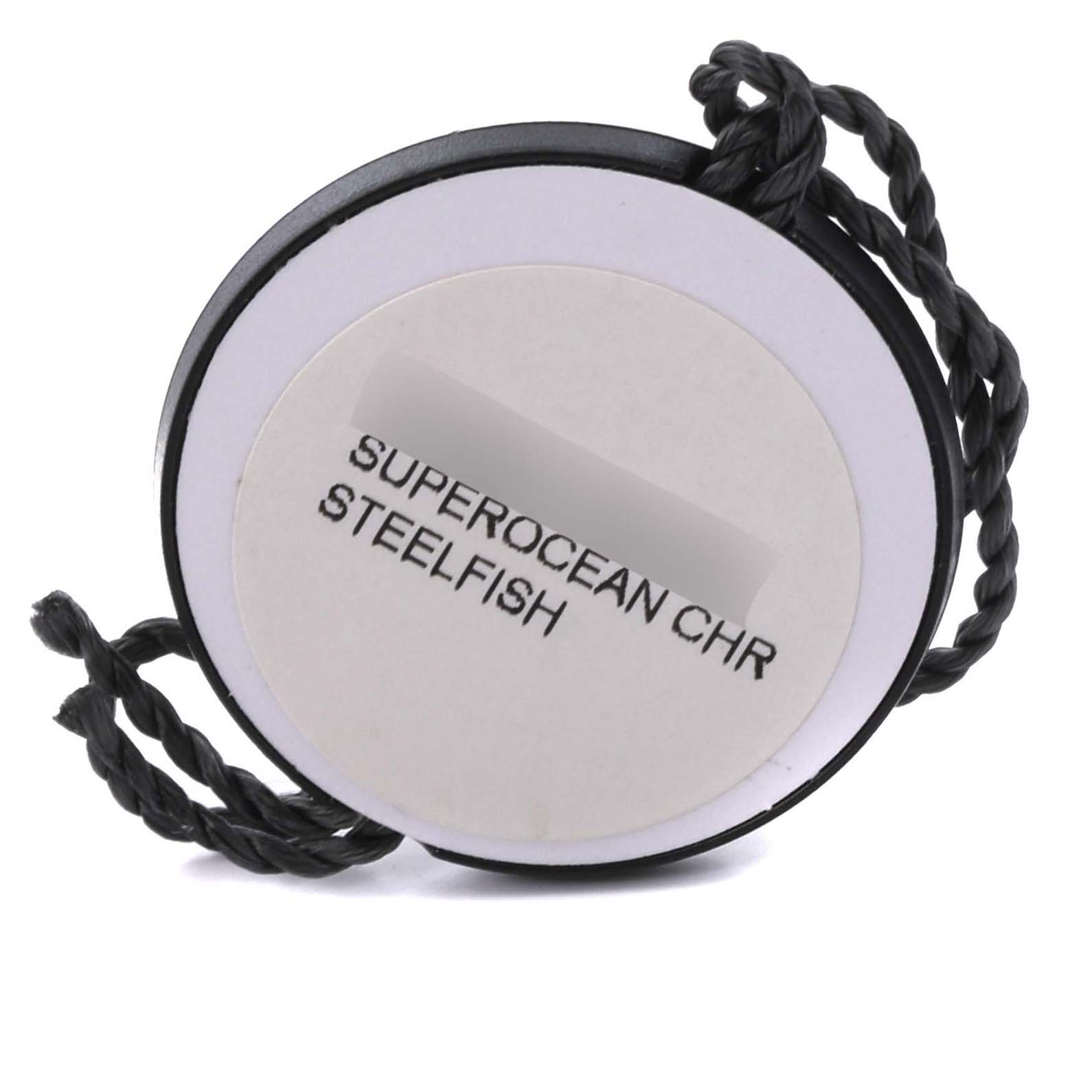 This image shows a Breitling Superocean Chronomat accessory tag, featuring the model name and a braided black cord.