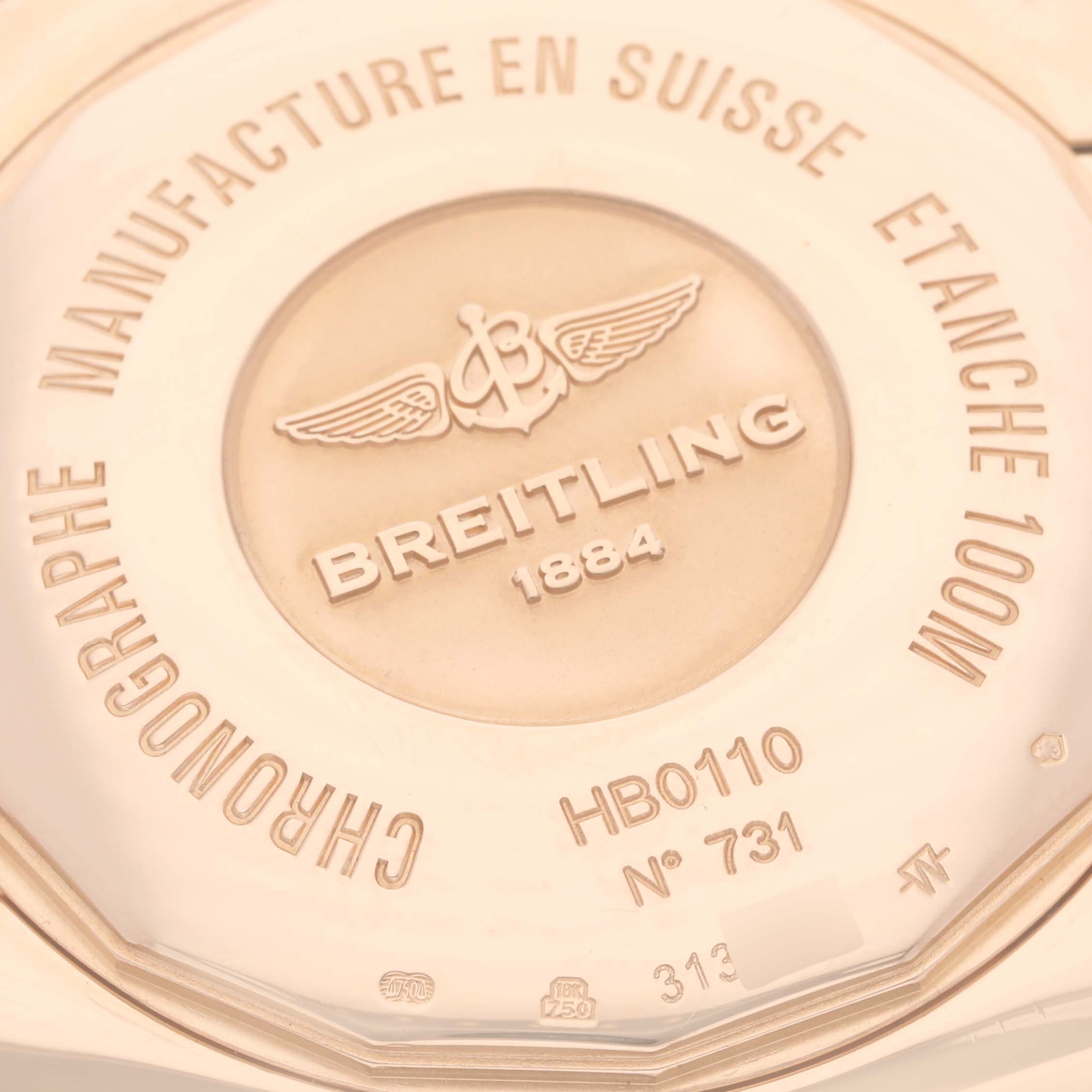 The image shows the back of a Breitling Chronomat HB0110 Men's Rose Gold Silver Dial watch with engraved branding and model details.