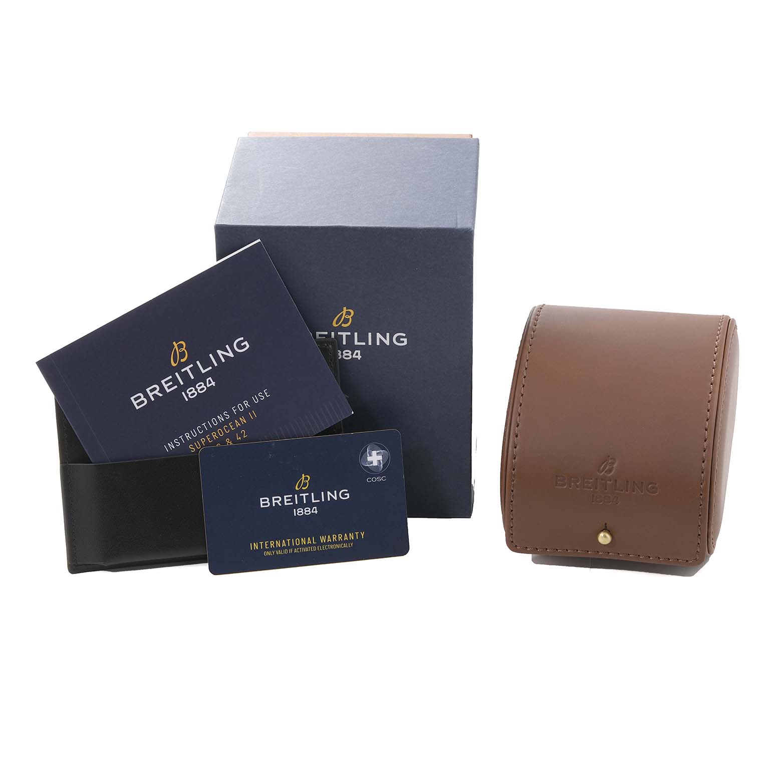 The image shows accessories for the Breitling Superocean A17365 Men's Stainless Steel Blue Dial A17365 Men's Stainless Steel Blue Dial watch including a box, instruction booklet, warranty card, and a leather case.