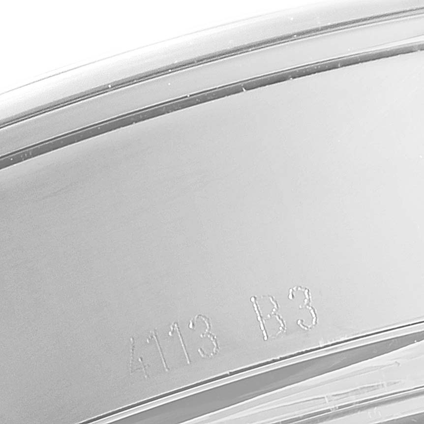 This image shows a close-up of the side of the case of a Breitling Transocean AB0510 Men
s Stainless Steel Silver Dial AB0510 Men
s Stainless Steel Silver Dial watch, focusing on the engraved serial number.