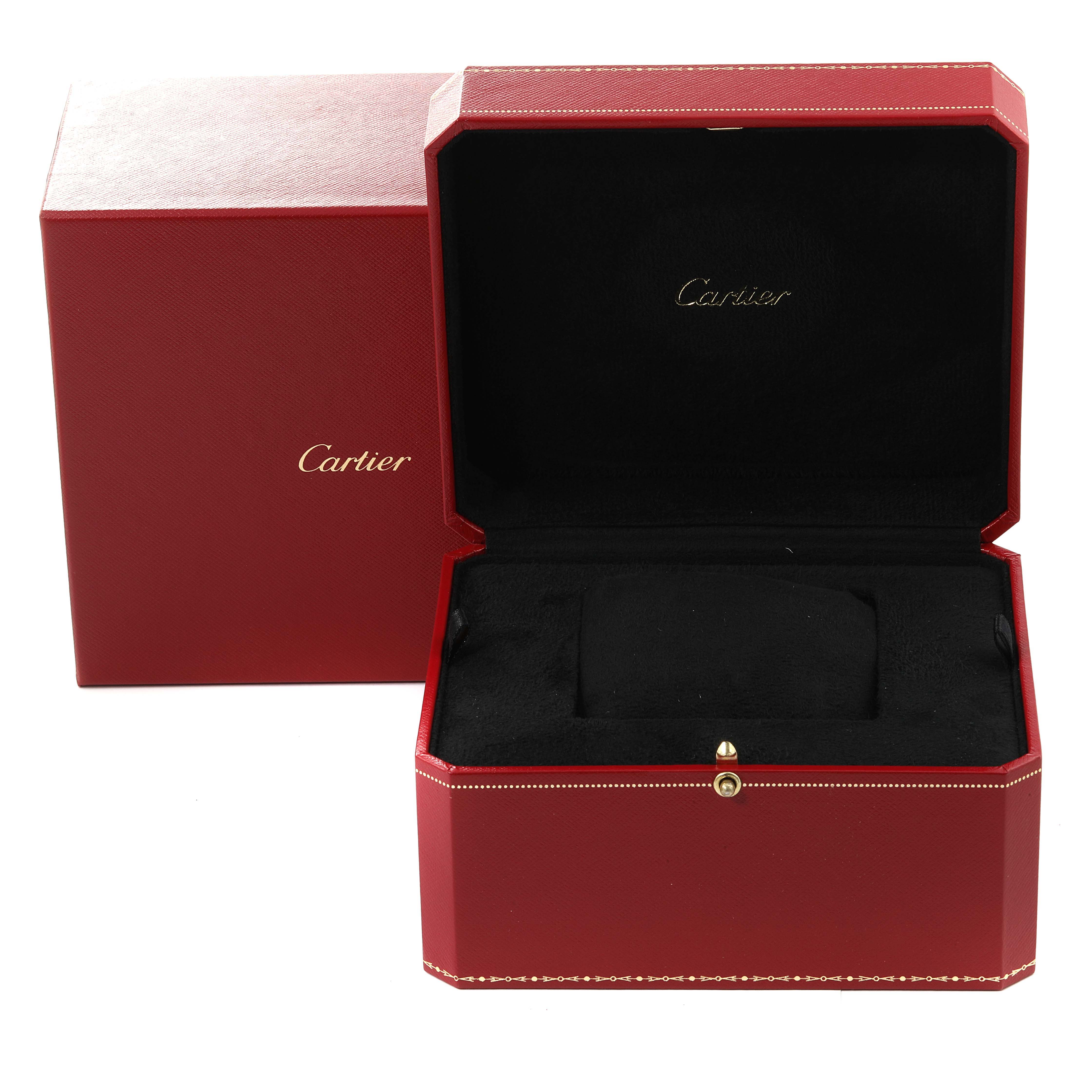 The image shows a red Cartier Tortue W1556234 Men
s Rose Gold Silver Dial watch box, open to reveal a black interior, with the brand
s name inside.