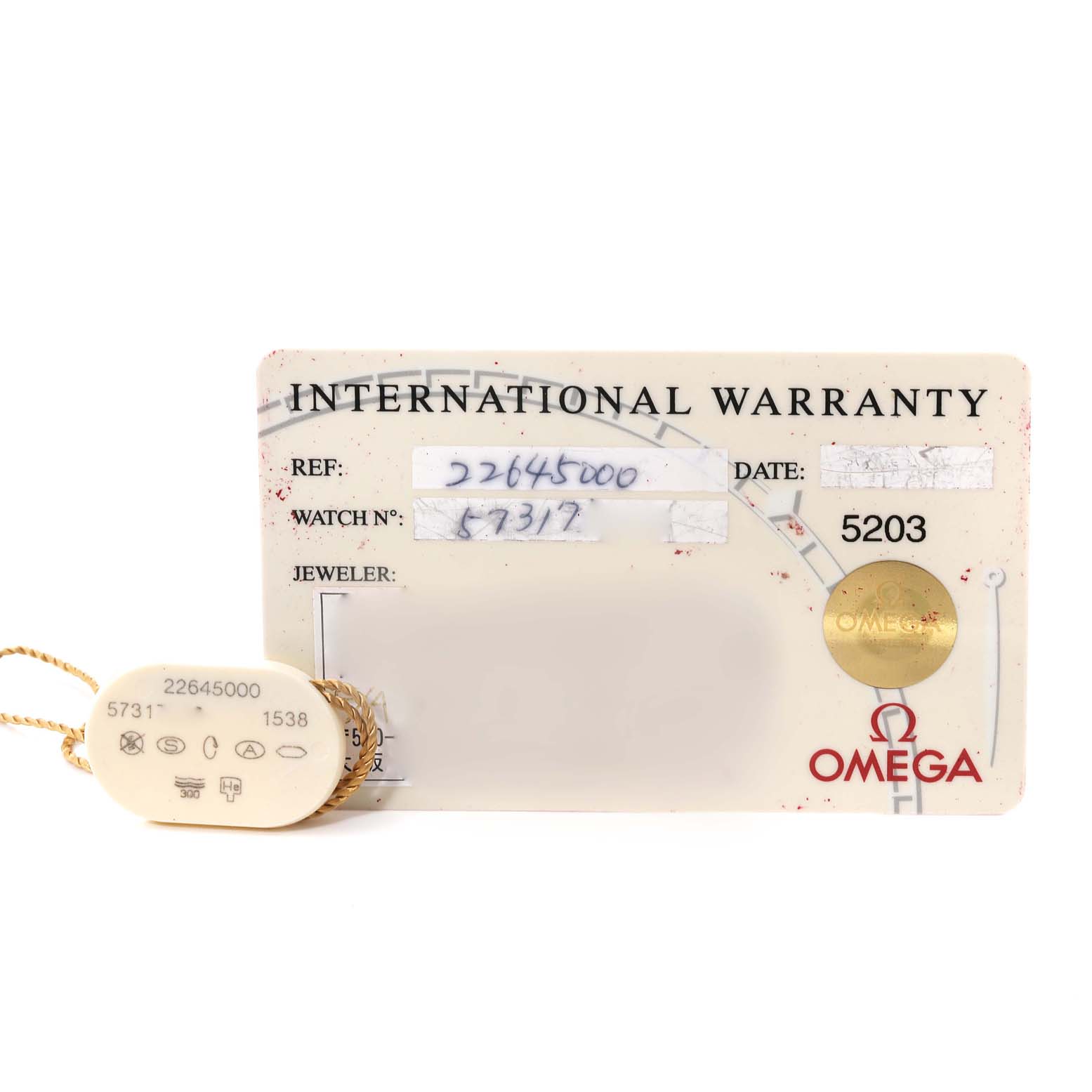 The image shows an Omega Seamaster 2264.50.00 Men's Stainless Steel Black Dial 2264.50.00 Men's Stainless Steel Black Dial International Warranty card alongside its attached identification tag.