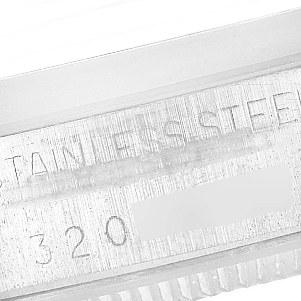 The image shows a close-up of the casing part of the Vintage Collection Rolex watch, displaying the "Stainless Steel" engraving and part of the serial number.