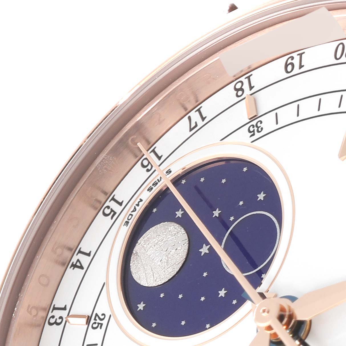 This close-up image of the Rolex Cellini 50535 Men's Rose Gold White Dial 50535 Men's Rose Gold White Dial watch showcases the dial, moon phase indicator, and a portion of the hour markers.