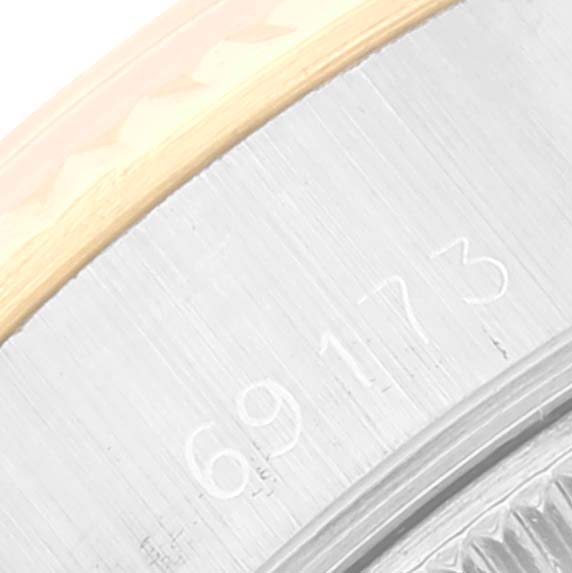 The image shows a close-up of the side of a Rolex Date 69173 Women's Steel and Gold (two tone) Silver Dial 69173 Women's Steel and Gold (two tone) Silver Dial model watch, specifically the case and serial number.