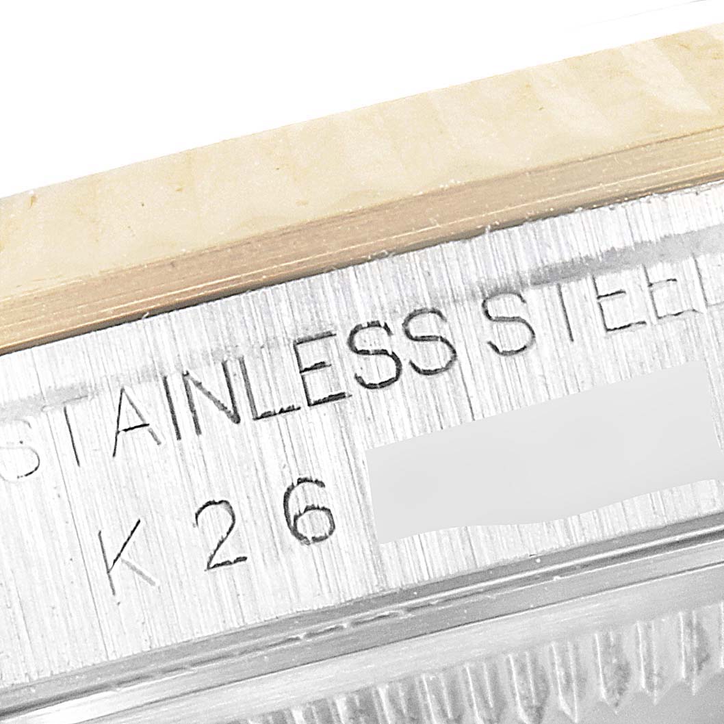 The image shows a close-up of the engraving on the case side of a Rolex Datejust 16233 Men's Steel and Gold (two tone) Black Dial 16233 Men's Steel and Gold (two tone) Black Dial watch.