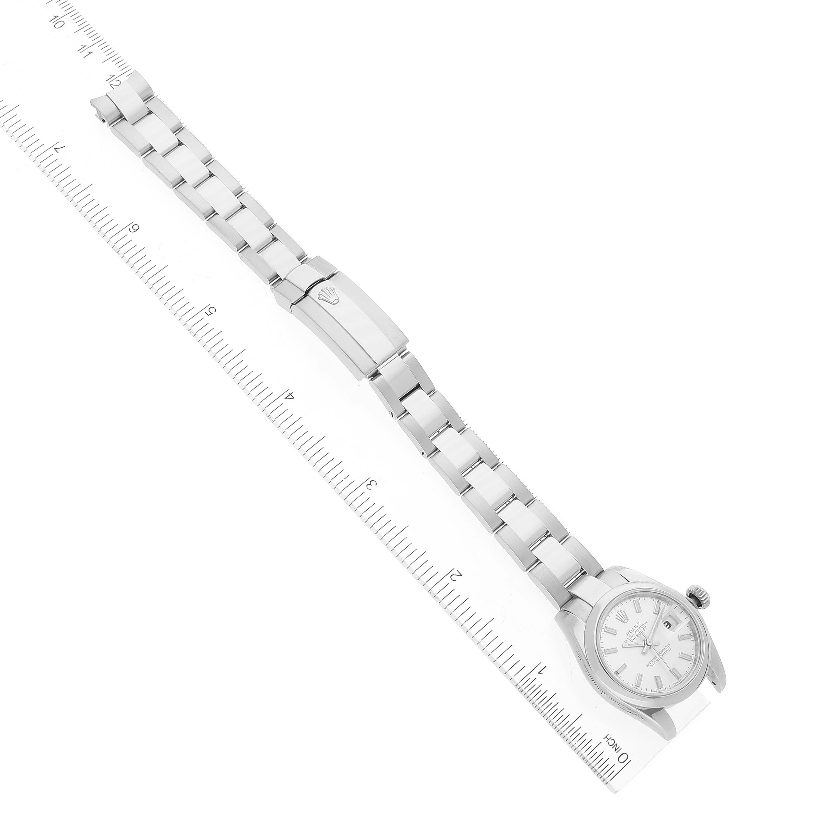 The image shows the entire Rolex Datejust 179160 Women's Stainless Steel Silver Dial 179160 Women's Stainless Steel Silver Dial watch laid flat alongside a measuring ruler, displaying the watch face and bracelet.