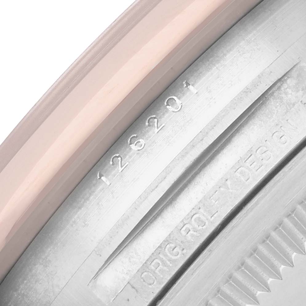 The image shows a close-up of the Rolex Datejust 126201 Men
s Steel and Gold (two tone) Black Dial model
s engraved inner bezel with reference numbers.