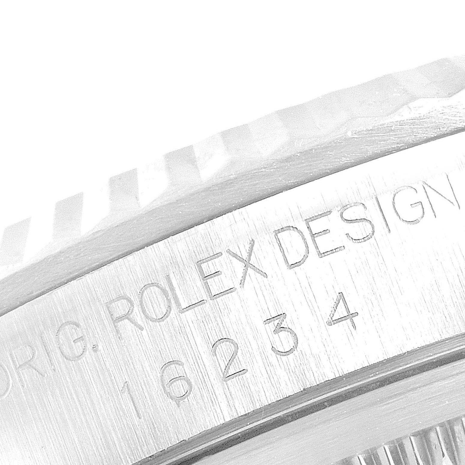This close-up image of the Rolex Datejust 16234 Men's Stainless Steel Blue Dial 16234 Men's Stainless Steel Blue Dial shows part of the bezel and engraved model number.