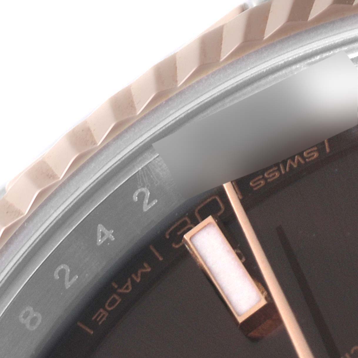 This close-up of the Rolex Datejust 41 126331 Men's Steel and Gold (two tone) Brown Dial 126331 Men's Steel and Gold (two tone) Brown Dial shows part of the bezel, dial, and hour markers, with a focus on the date display.