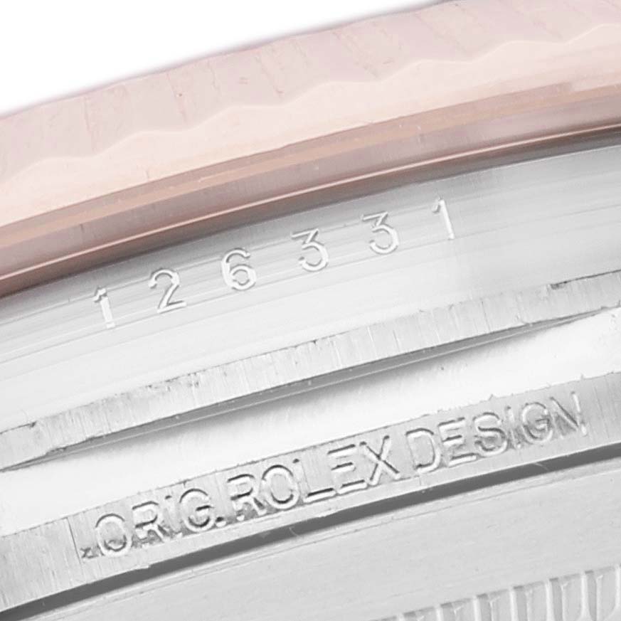 This image shows a close-up of the case and bezel of the Rolex Datejust 41 126331 Men's Steel and Gold (two tone) Brown Dial 126331 Men's Steel and Gold (two tone) Brown Dial, highlighting its serial number and "ORIG. ROLEX DESIGN".