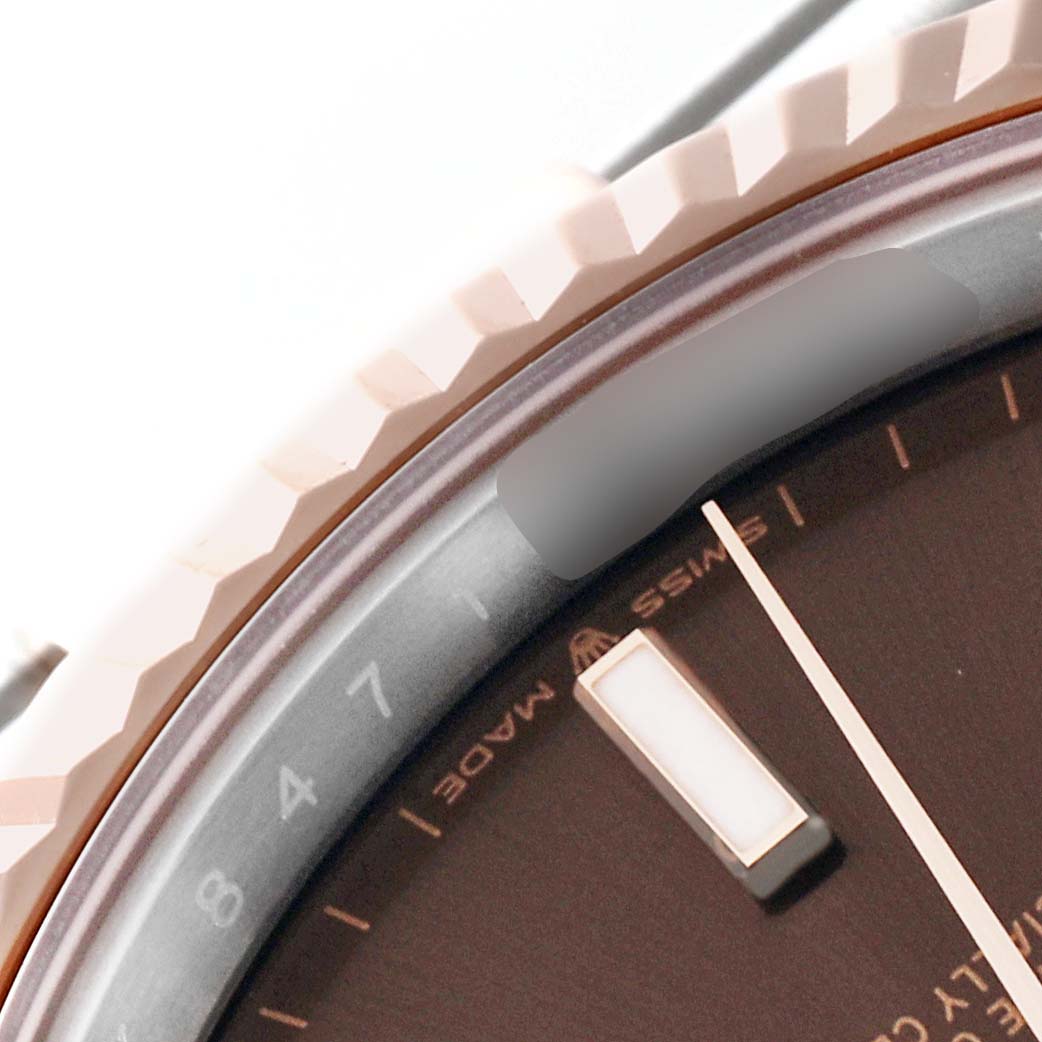 The image shows a close-up of the bezel, part of the dial, and a marker of the Rolex Datejust 41 126331 Men's Steel and Gold (two tone) Brown Dial 126331 Men's Steel and Gold (two tone) Brown Dial watch.