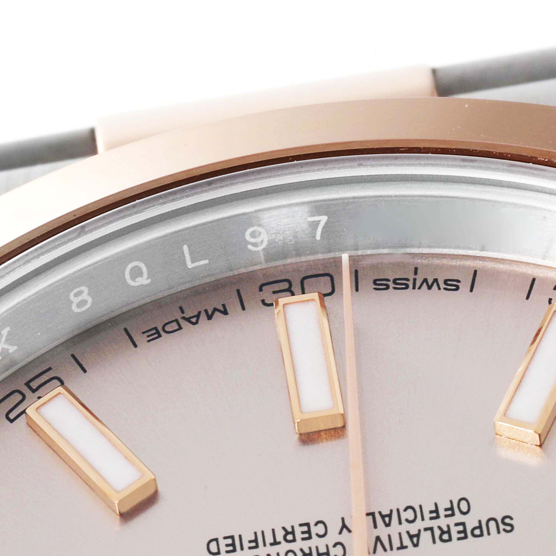 This close-up image of a Rolex Datejust 41 126301 Men
s Steel and Gold (two tone) Pink Dial 126301 Men
s Steel and Gold (two tone) Pink Dial watch displays part of the dial and hour markers.