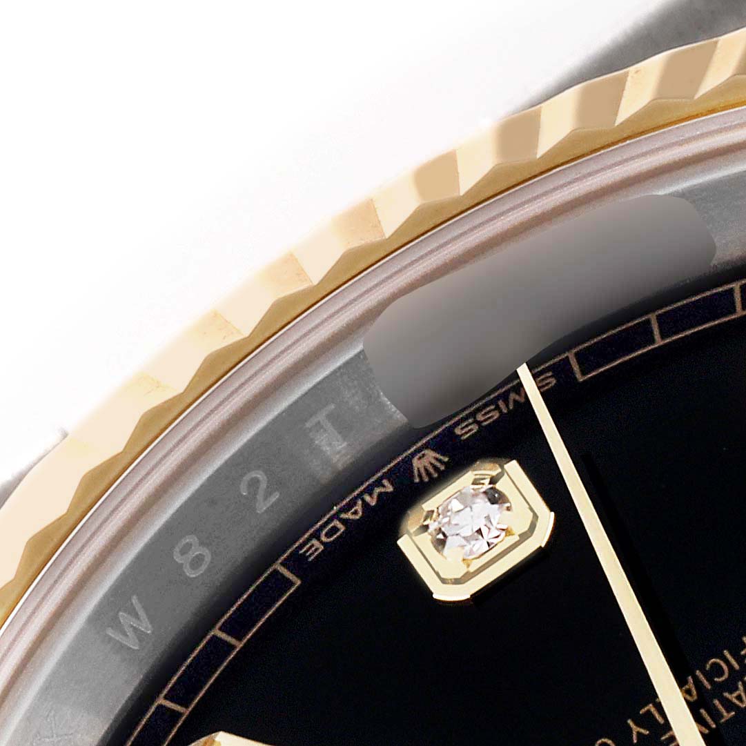 This image shows a close-up of the bezel, dial, and watch hand of a Rolex Datejust 41 126333 Men's Steel and Gold (two tone) Black Dial 126333 Men's Steel and Gold (two tone) Black Dial model.