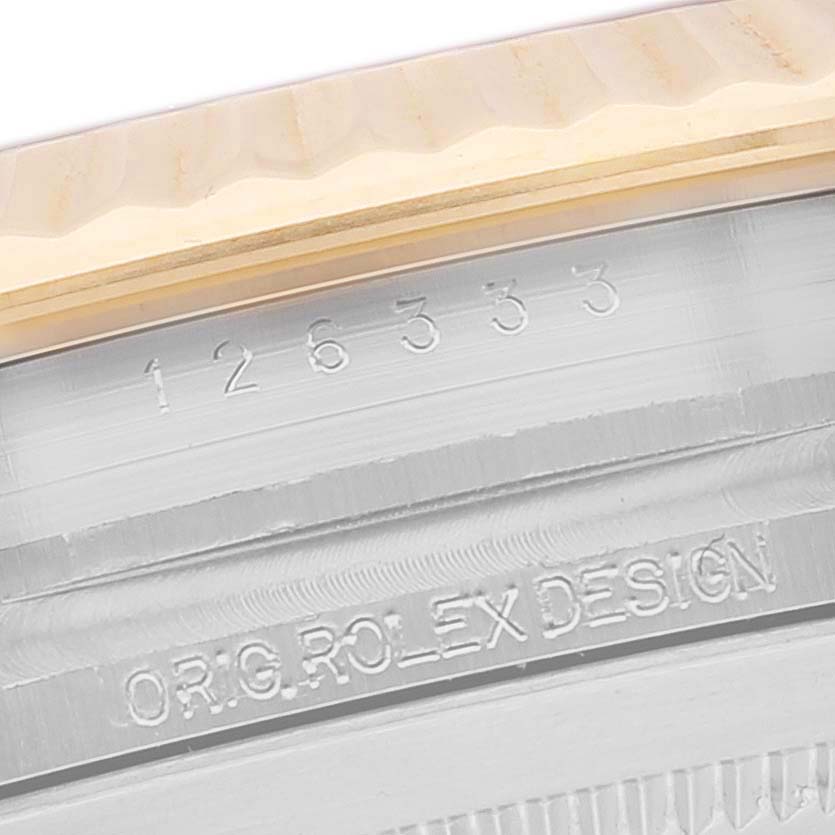 This image shows a close-up view of the Rolex Datejust 41 126333 Men's Steel and Gold (two tone) Black Dial 126333 Men's Steel and Gold (two tone) Black Dial model bezel and serial number engraving.