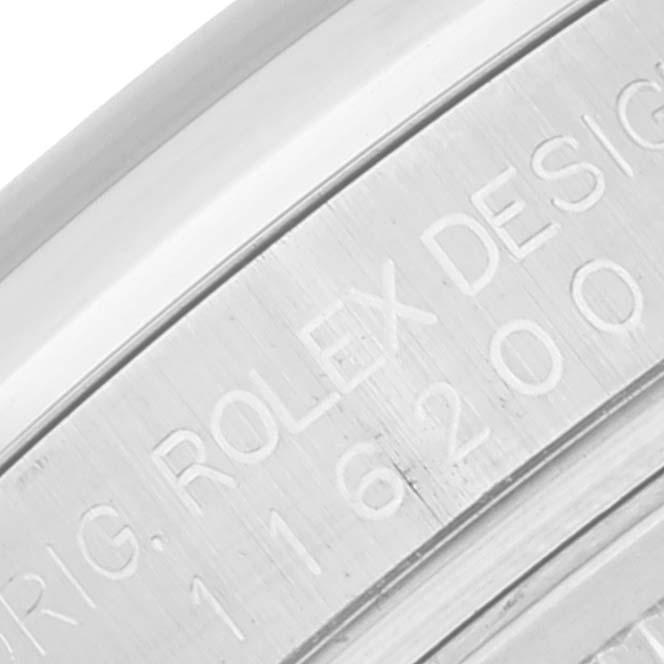 This is a close-up view of the engraved bezel on a Rolex Datejust 116200 Men's Stainless Steel Blue Dial 116200 Men's Stainless Steel Blue Dial watch, displaying part of the model number and branding.