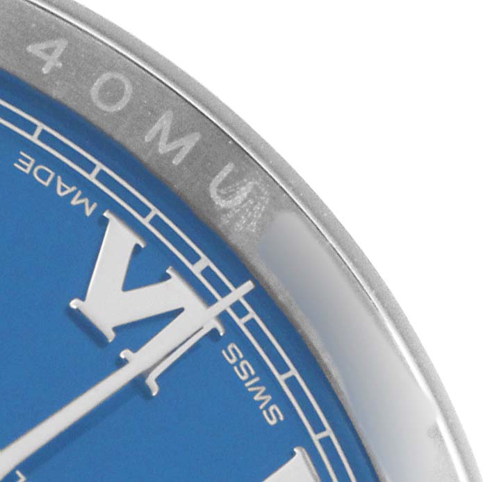 The image shows a close-up of the dial and bezel edge of a Rolex Datejust 116200 Men
s Stainless Steel Blue Dial watch from an angled top view.